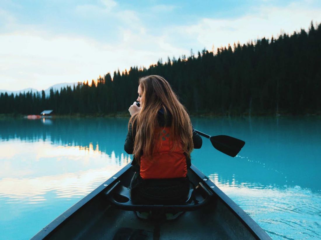 A canoe gliding across still turquoise water