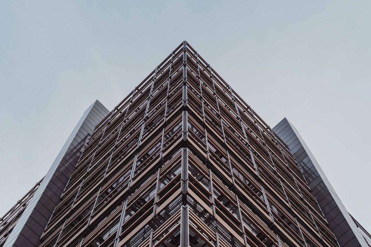 Dark steel and glass building meeting at a sharp corner